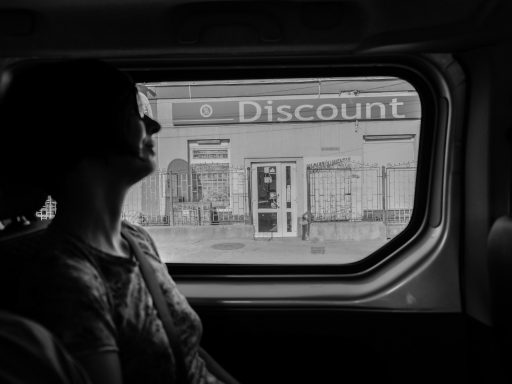 greyscale photography of woman inside vehicle