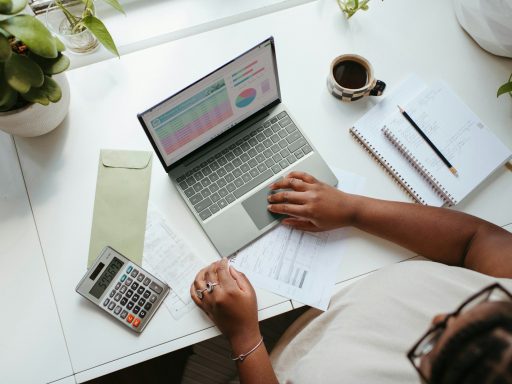 a person sitting at a table with a laptop