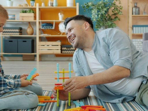 Father and son playing with building blocks together