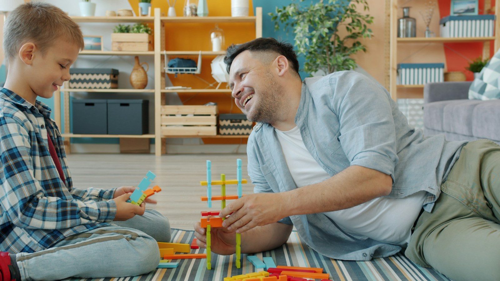 Father and son playing with building blocks together